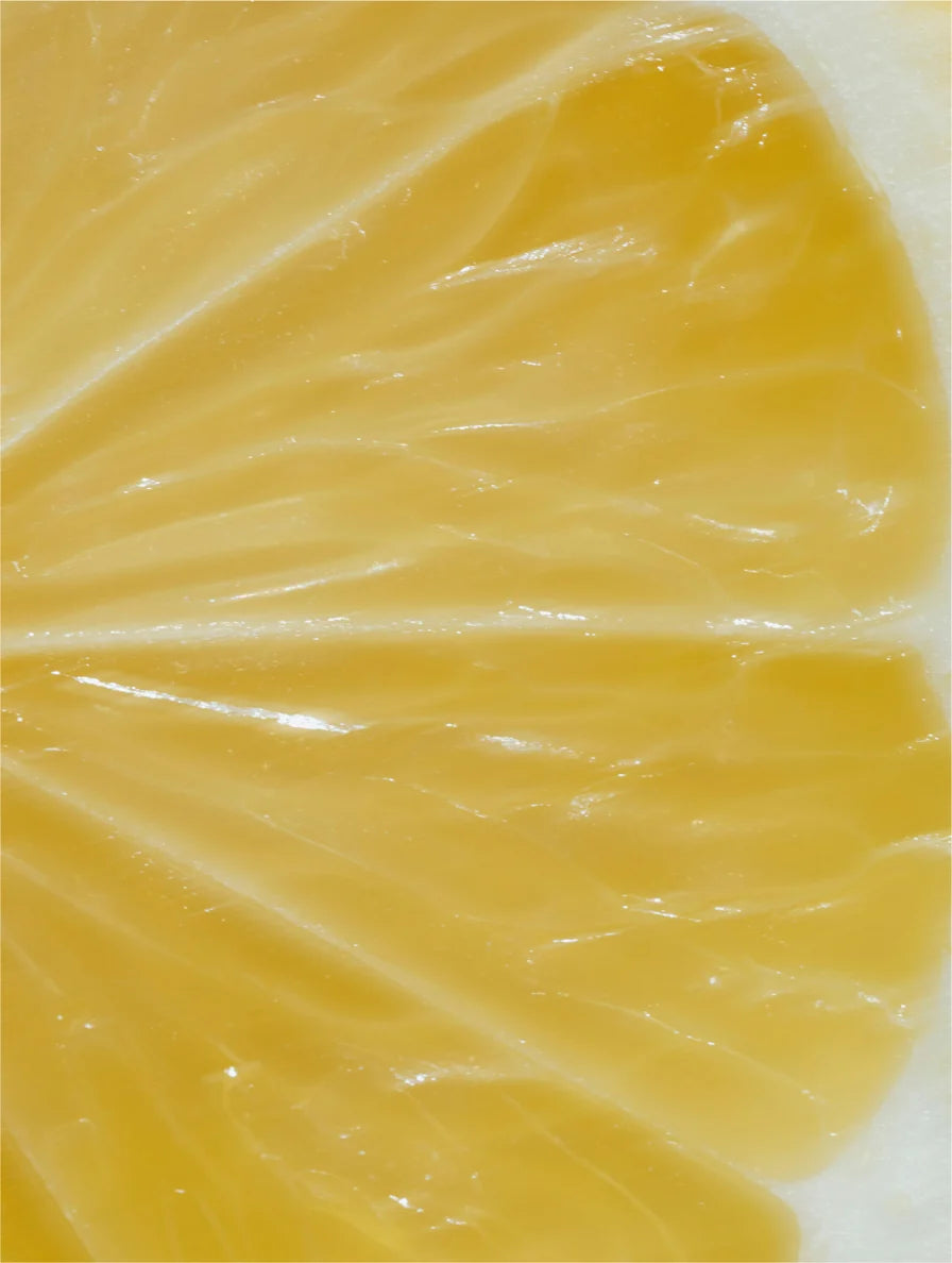 Close-up of a yellow fruit slice with a white background