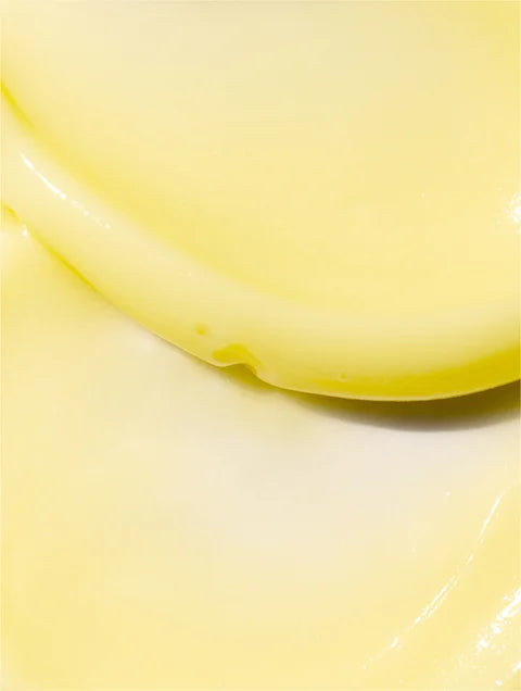 Close-up of a yellow liquid in a container on a white background
